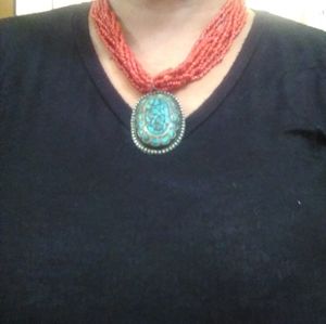 Woman necklace with turquoise pendant.